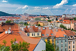 View of Prague Castle over red roof from Vysehrad area at sunset lights, Prague, Czech Republic. Scenic view of Prague city,