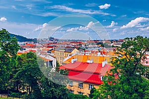 View of Prague Castle over red roof from Vysehrad area at sunset lights, Prague, Czech Republic. Scenic view of Prague city,