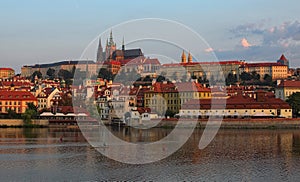 View of the Prague Castle with Saint Vitus Cathedral in the historic city center in Prague by the Vltava River during sunrise
