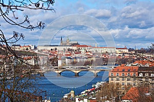 View of Prague city Prague Castle, Vltava river with bridges under dramatic sky with clouds - Czech Republic