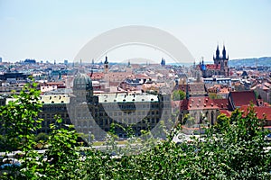 View of Prague and river Vltava with ships and amazing buildings with red roofs.