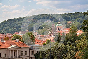 View on Prague roofs with church and trees