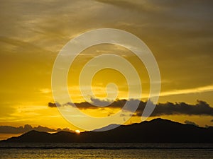 View of Praslin island from La Digue island beach at sunset. Seychelles