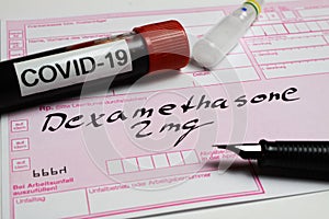 View on prescription form with word dexamethasone and covid-19 blood sample tube