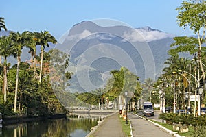 Promenade with trees of river Pereque-Acu and mountains, Paraty, Brazil