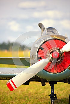 View on propeller on old russian airplane on green grass