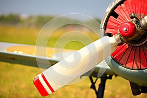 View on propeller on old russian airplane on green grass