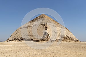 View of Pyramid of Snefru, Bent Pyramid on a blue sky background, at Dahshur, Egypt. southern pyramid in Dahshur is called cut or
