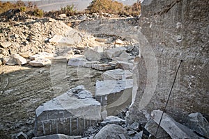 View into a quarry mine for porphyry rocks. Mining industry. Construction material production.