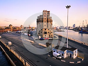 View of a quay of the port of Livorno at sunset. Old abandoned building. Industrial archeology