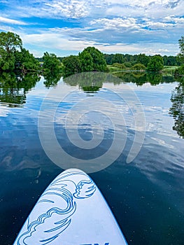 A view of the quiet surface of the lake from a sup board.
