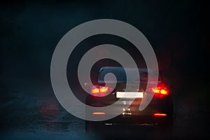 View from a rain-drenched windshield on a car in front.