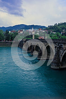 View in the Rainy Day to the historic Mehmed PaÅ¡a SokoloviÄ‡ Bridge Bridge in ViÅ¡egrad, over the Drina River