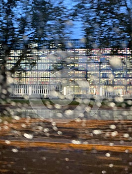 View through the rainy windshield of a car blurred city