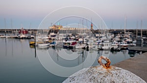 View of Ramsgate Royal Harbour taken in the early evening light, with the masts of the yachts reflected in the water.