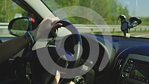 View in the rear view side mirror of a auto, driving a red car along the track