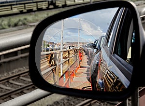View through the rearview mirror of cars on the upper deck of a car train photo