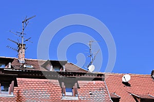 View of Red and brown tile cladding roof with dormer windows or roof windows.