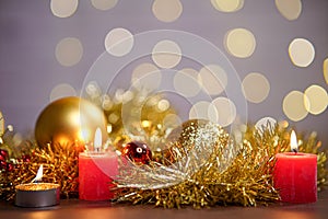 View of red candle lights of with Christmas ornaments on the table with bokeh background