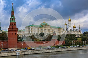 View of the red Kremlin wall, tower and golden onion domes of cathedrals over the Moskva River in Moscow, Russia