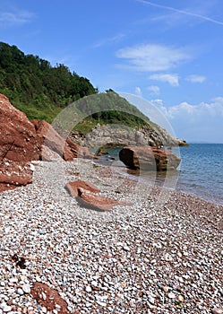 A view of the red rocky beach at Oddicombe