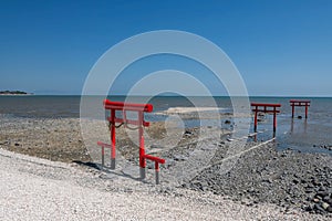 View of red torii gates at Oouo Shrine by sea, Tara, Saga
