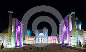 View of Registan square in Samarkand with Ulugbek madrassas, Sherdor madrassas and Tillya-Kari madrassas at night with multicolore photo