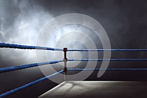 View of a regular boxing ring surrounded by blue ropes photo