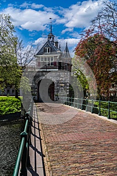 Historic Oosterpoort city gate with stone arch bridge in Hoorn, Netherlands in spring photo