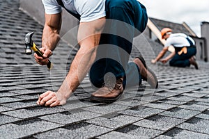 View of repairmen in uniform working on rooftop