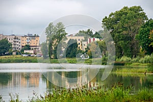 View of residential buildings and the embankment on Kirov Street across Lake Bologoe. City Bologoe