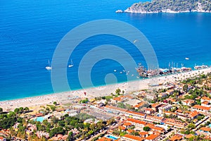 view of the resort beach and tourist ships and yachts in the blue sea lagoon. Vacation and coast in Turkey