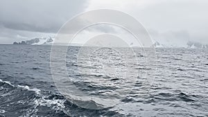 view from a retro style sailing schooner during the passage near the Antarctic peninsula at the South Pole, wooden boat