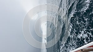 view from a retro style sailing schooner during the passage near the Antarctic peninsula at the South Pole, wooden boat