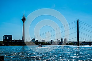 View of the RheinkniebrÃ¼cke bridge over the river and the Rhine Tower in Dusseldorf, Germany