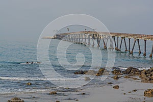 View of Richfield Pier out to Rincon Island on the Pacific Ocean. In Mussel Shoals, Ventura County, California