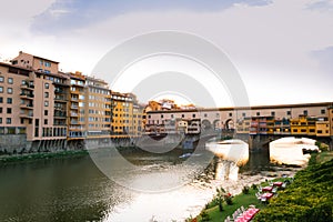 View of the river Arno lined with Santa Maria della Spina church and colorful buildings in the city of Pisa