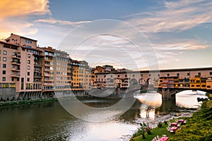 View of the river Arno lined with Santa Maria della Spina church and colorful buildings in the city of Pisa