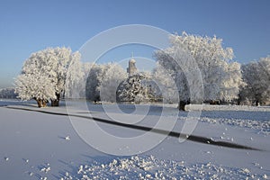 View on river bank and city of Deventer, The Netherlands, covered with snow