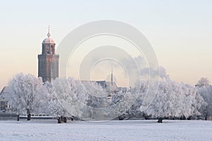 View on river bank and city of Deventer, The Netherlands, covered with snow