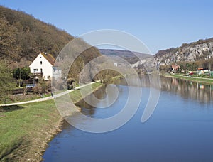 View on river Berounka from pedestrial bridge in village Srbsko in central Bohemian region on on spring sunny day, blue