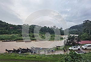 View of the river, boats, cars and tropical jungle in Kuala Tahan (Taman Negara National Park in Malaysia)