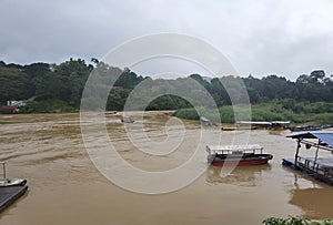 View of the river, boats and tropical jungle in Kuala Tahan (Taman Negara National Park in Malaysia)