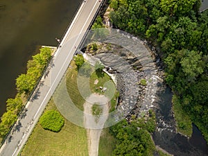 View of a river, a bridge and a little dam, from the sky. Cowansville, Quebec, Canada