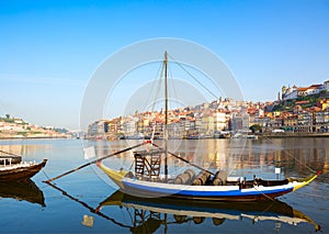 View of river Douro with the traditional wooden boat, Porto city in the background, Portugal