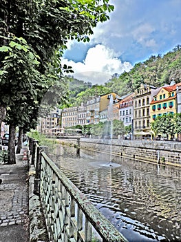 View of river, fountain and houses in Karlovy Vary, Czech Republic