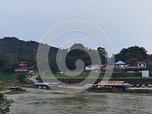View of the river, harbor boats and Kuala Tahan village in Taman Negara National Park in Malaysia
