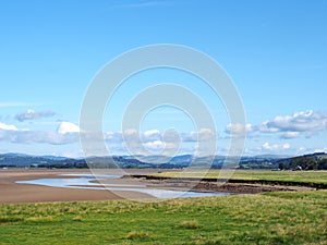 View of the river kent near arnside and sandside in cumbria with surrounding lakeland hills