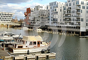 View of river Main and 30-story skyscraper Westhafen tower, modern residential buildings, Gutleitviertel district, boats and