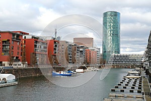 View of river Main and Westhafen tower, modern residential buildings, 30-story skyscraper Westhafen Tower in Gutleitviertel